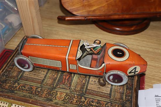 A Chad Valley tinplate racing car and a collection of other tinplate clockwork models,